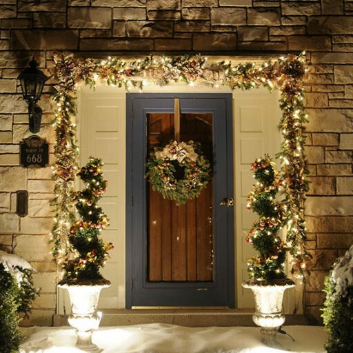 Colonial Christmas front entrance in champagne gold and blush at night with white lights
