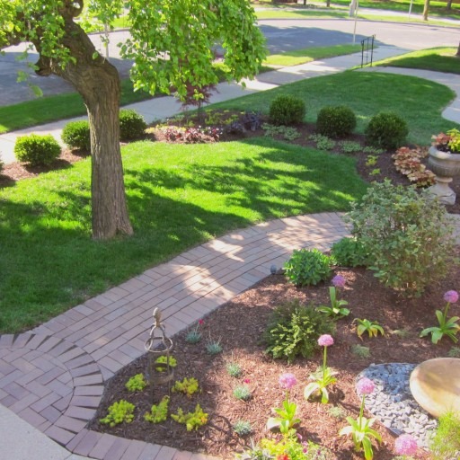 Craftsman Front Yard: After Design front yard around existing hardscape with four season plantings suitable for variable lighting and moisture conditions. Incorporate existing garden accessories into beds, and eliminate mowing challenges of slope.
